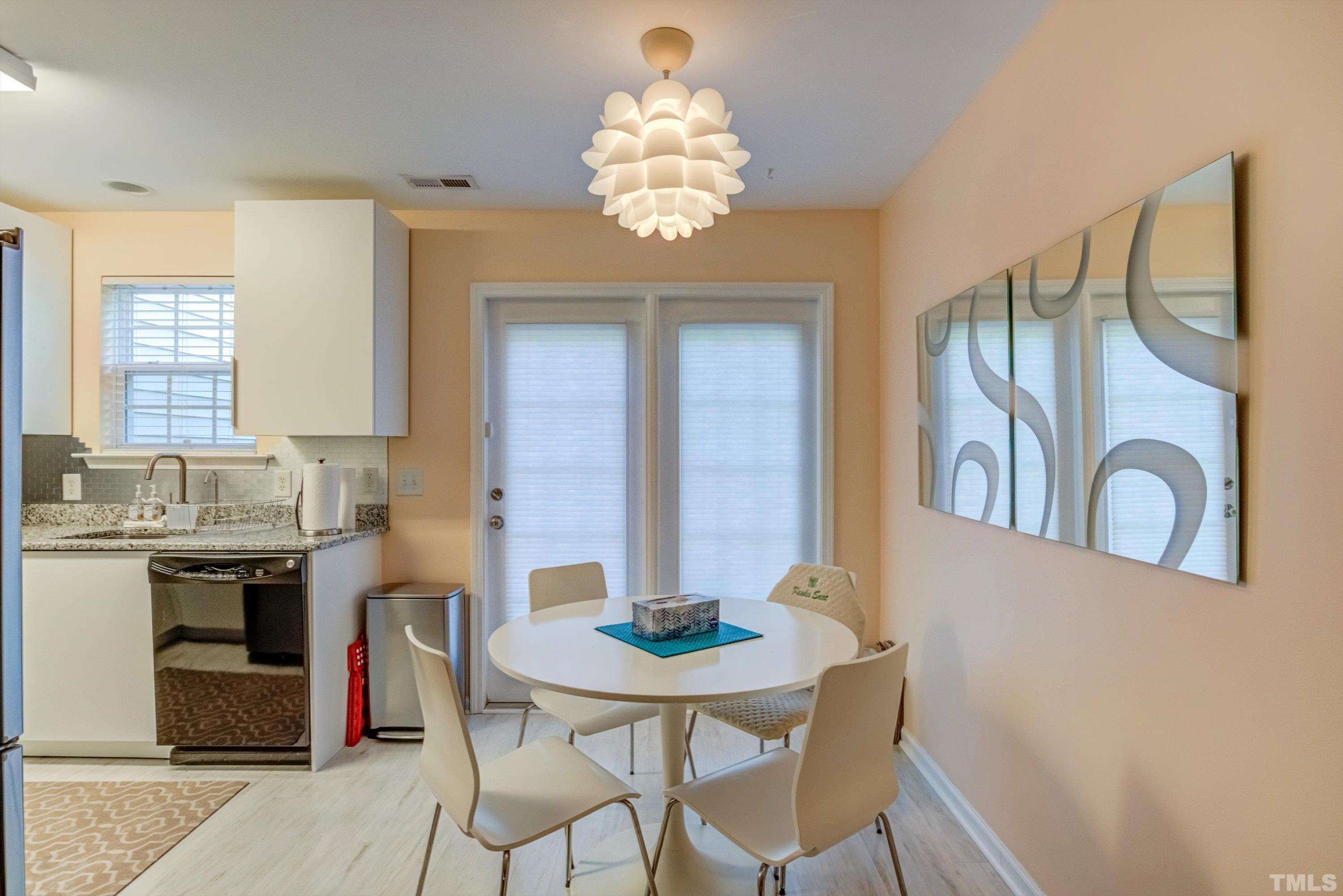 7846 Averette Field Drive Raleigh, NC 27616 - Photo 10 of 21 a kitchen with a table and chairs in it
