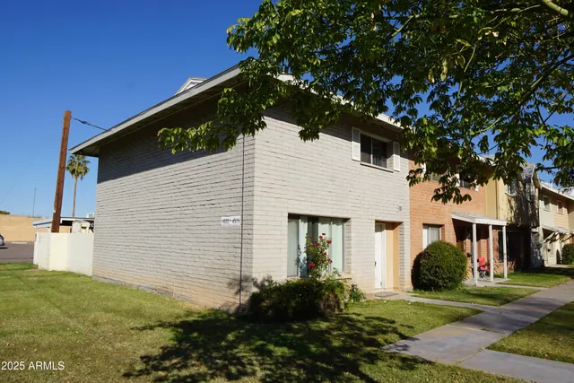 a view of a white house with a yard