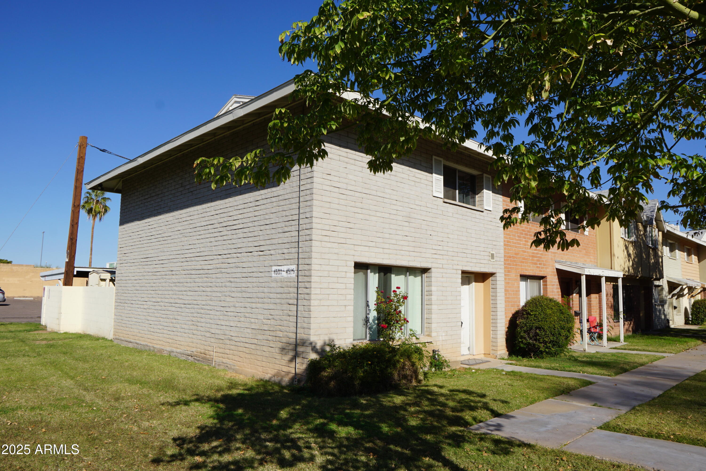 a view of a white house with a yard