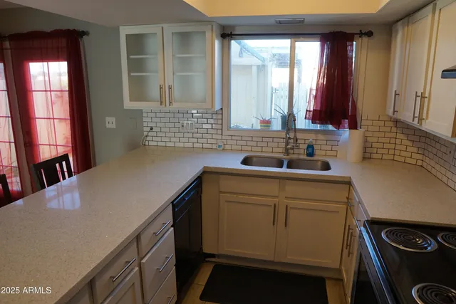 a kitchen with a stove a sink and a microwave