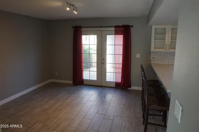 a view of a room with wooden floor and a window