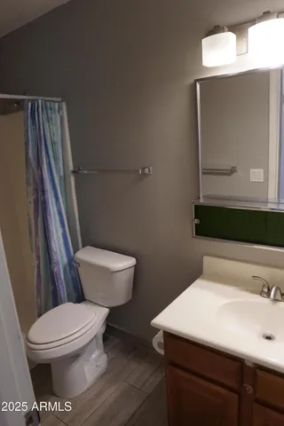 an empty room with a chandelier fan and a large window