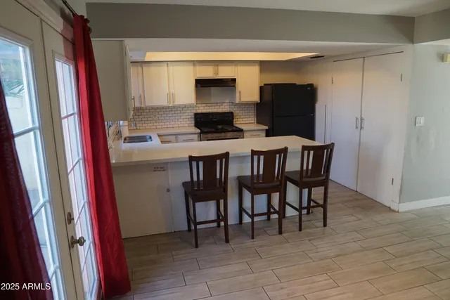 a kitchen with a sink cabinets and window