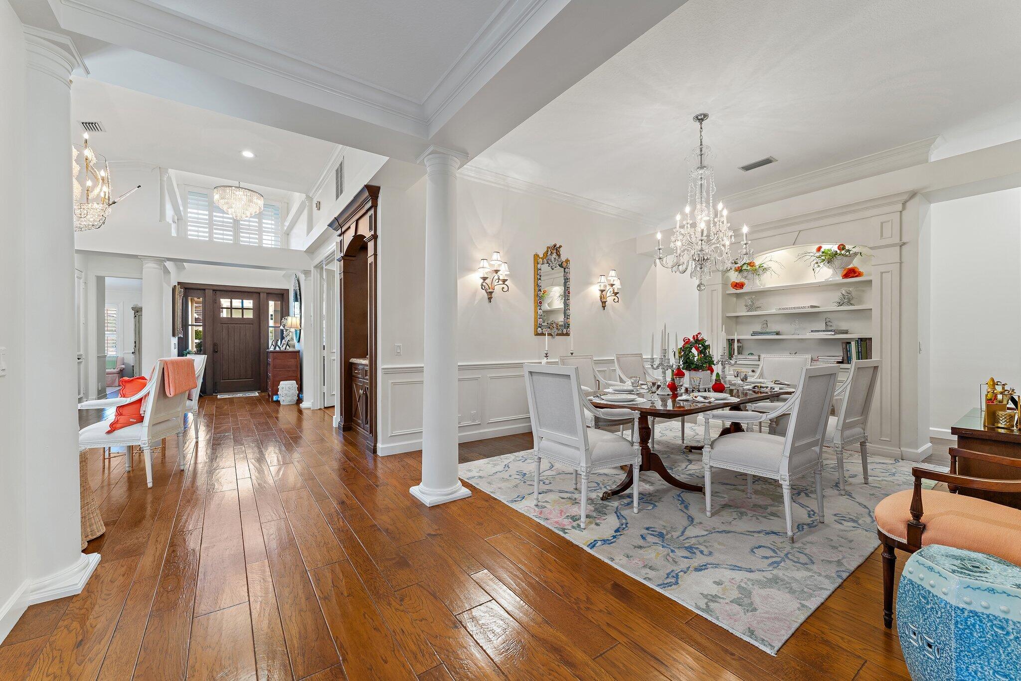 3230 West Channel Circle Jupiter, FL 33477 - Photo 13 of 67 a view of a dining room and livingroom with furniture wooden floor a chandelier