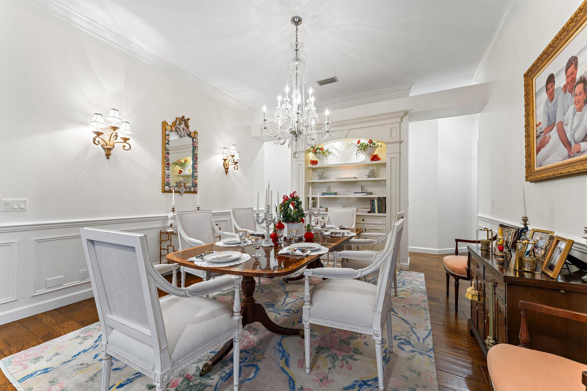 3230 West Channel Circle Jupiter, FL 33477 - Photo 14 of 67 a view of a dining room with furniture wooden floor and a chandelier