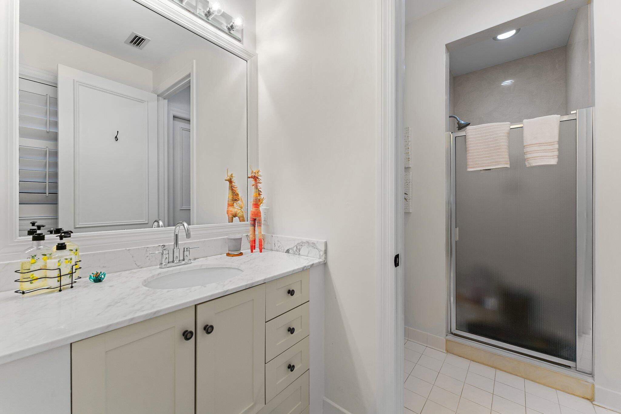 3230 West Channel Circle Jupiter, FL 33477 - Photo 18 of 67 a bathroom with a sink and a mirror