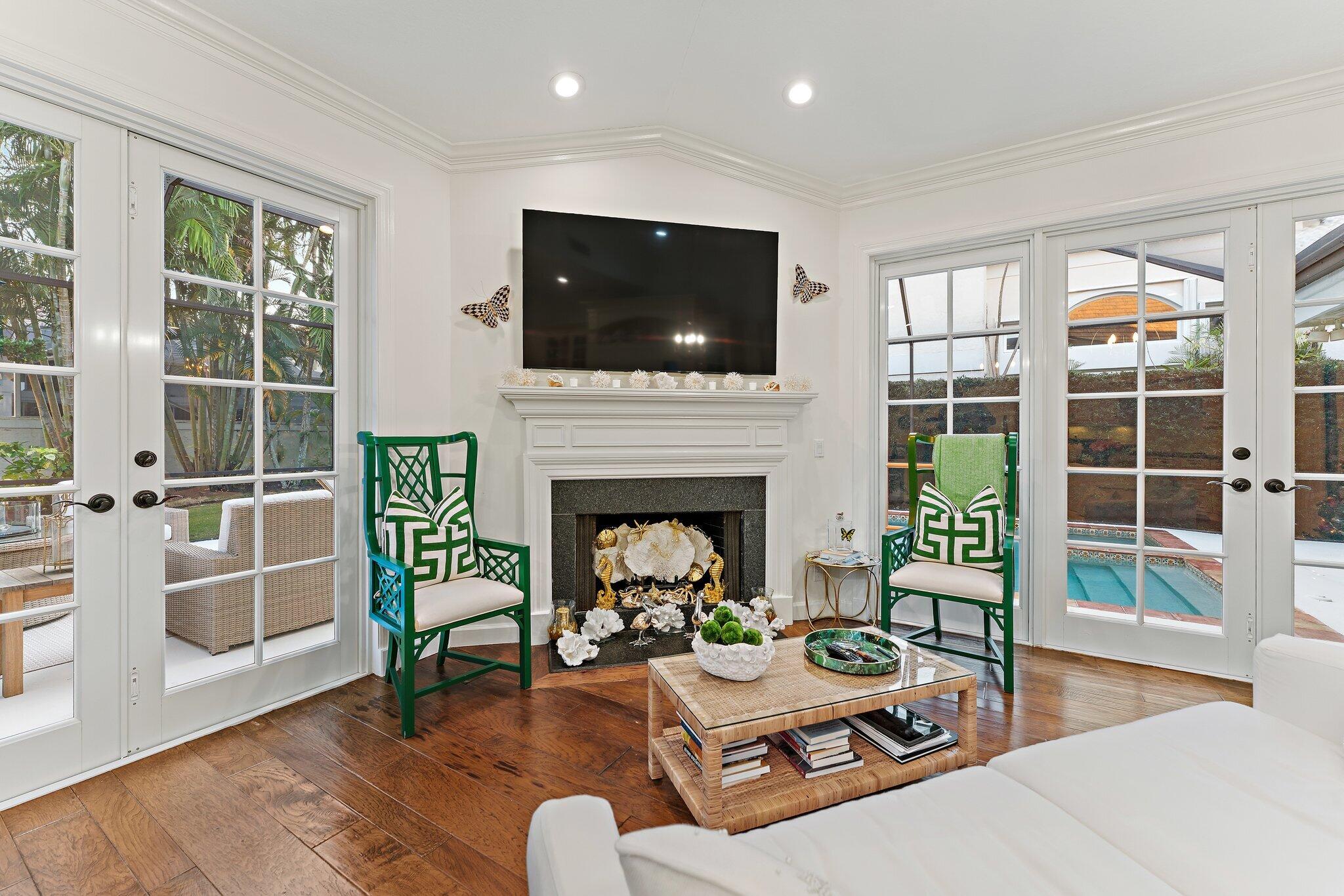 3230 West Channel Circle Jupiter, FL 33477 - Photo 24 of 67 a living room with furniture a fireplace and a flat screen tv