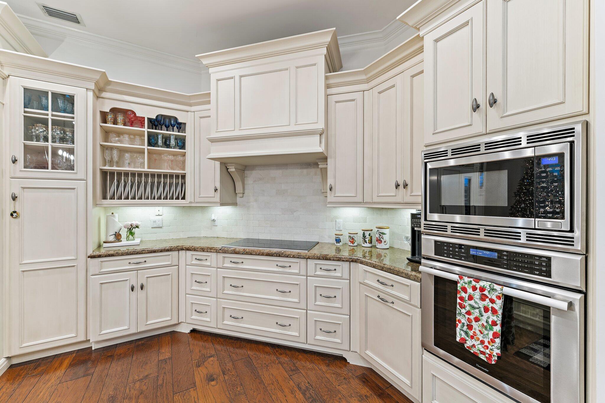 3230 West Channel Circle Jupiter, FL 33477 - Photo 28 of 67 a kitchen with stainless steel appliances granite countertop a stove and cabinets