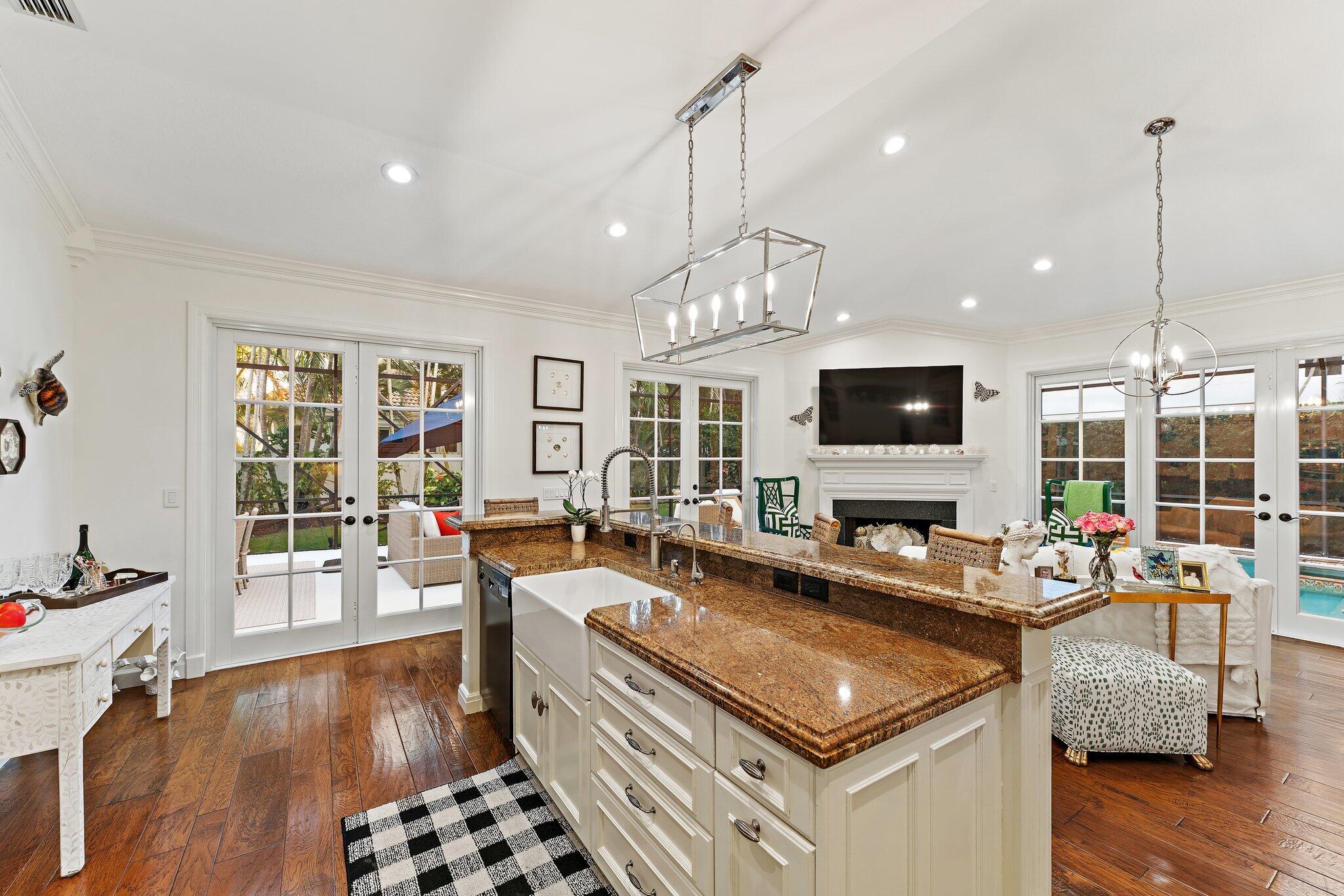3230 West Channel Circle Jupiter, FL 33477 - Photo 29 of 67 a kitchen with stainless steel appliances granite countertop a stove and a flat screen tv
