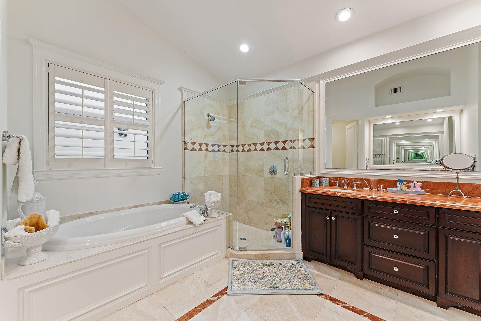 3230 West Channel Circle Jupiter, FL 33477 - Photo 35 of 67 a spacious bathroom with a tub sink shower double vanity and mirror