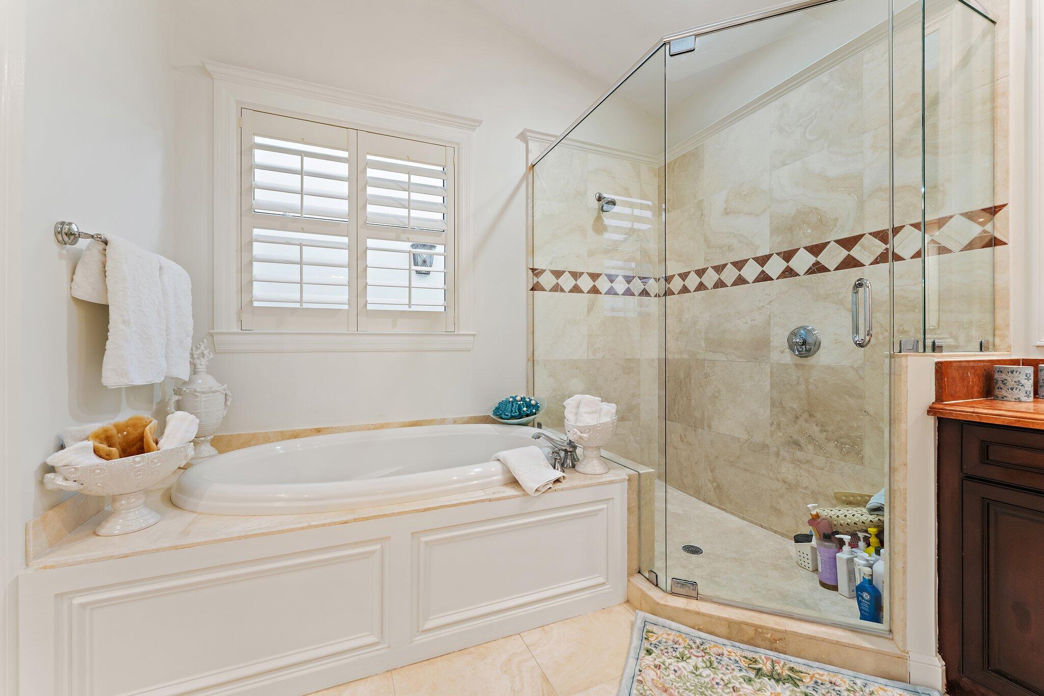 3230 West Channel Circle Jupiter, FL 33477 - Photo 37 of 67 a bathroom with a tub and a shower