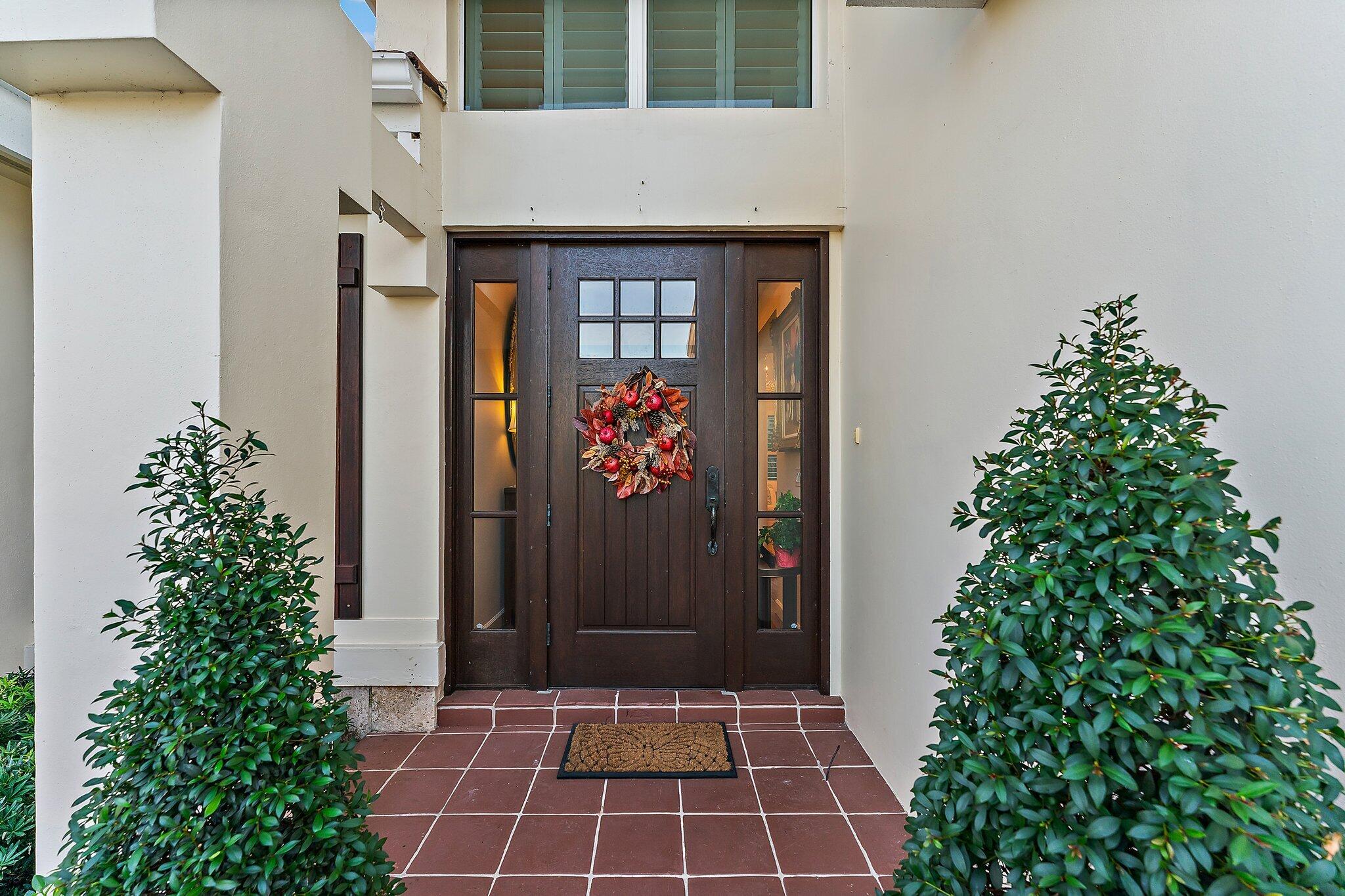 3230 West Channel Circle Jupiter, FL 33477 - Photo 9 of 67 a front view of a house with a shower
