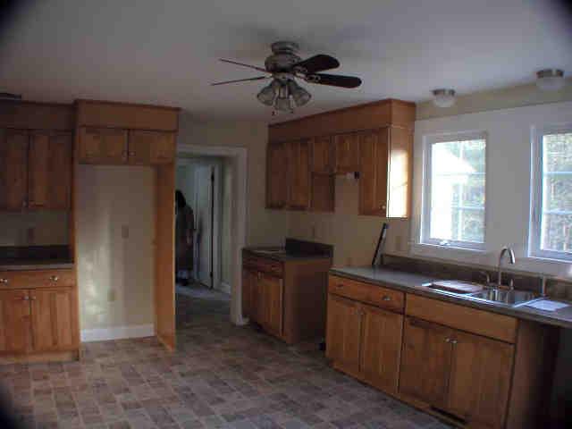 591 Colebrook River Road Tolland, MA 01034 - Photo 2 of 10 a kitchen with cabinets a refrigerator and a sink