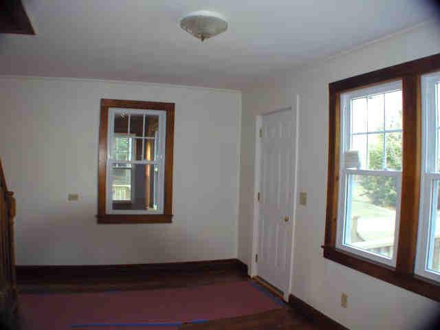 591 Colebrook River Road Tolland, MA 01034 - Photo 5 of 10 a view of an empty room with wooden floor and a window