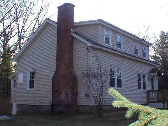 591 Colebrook River Road Tolland, MA 01034 - Photo 6 of 10 a front view of a house with a garden