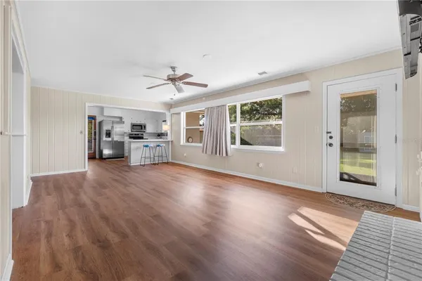 a view of a house with a big yard and large trees