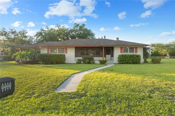 a bathroom with a toilet a sink a mirror a vanity and shower