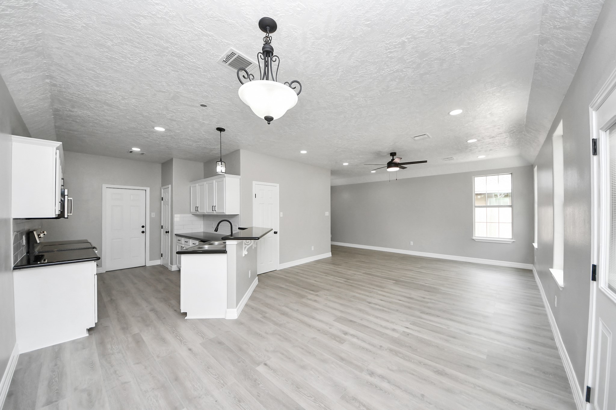 1105 East Kyle Road Clute, TX 77531 - Photo 43 of 44 The spacious open-concept floor plan leaves a great flow from the dining area into the living area and kitchen.
