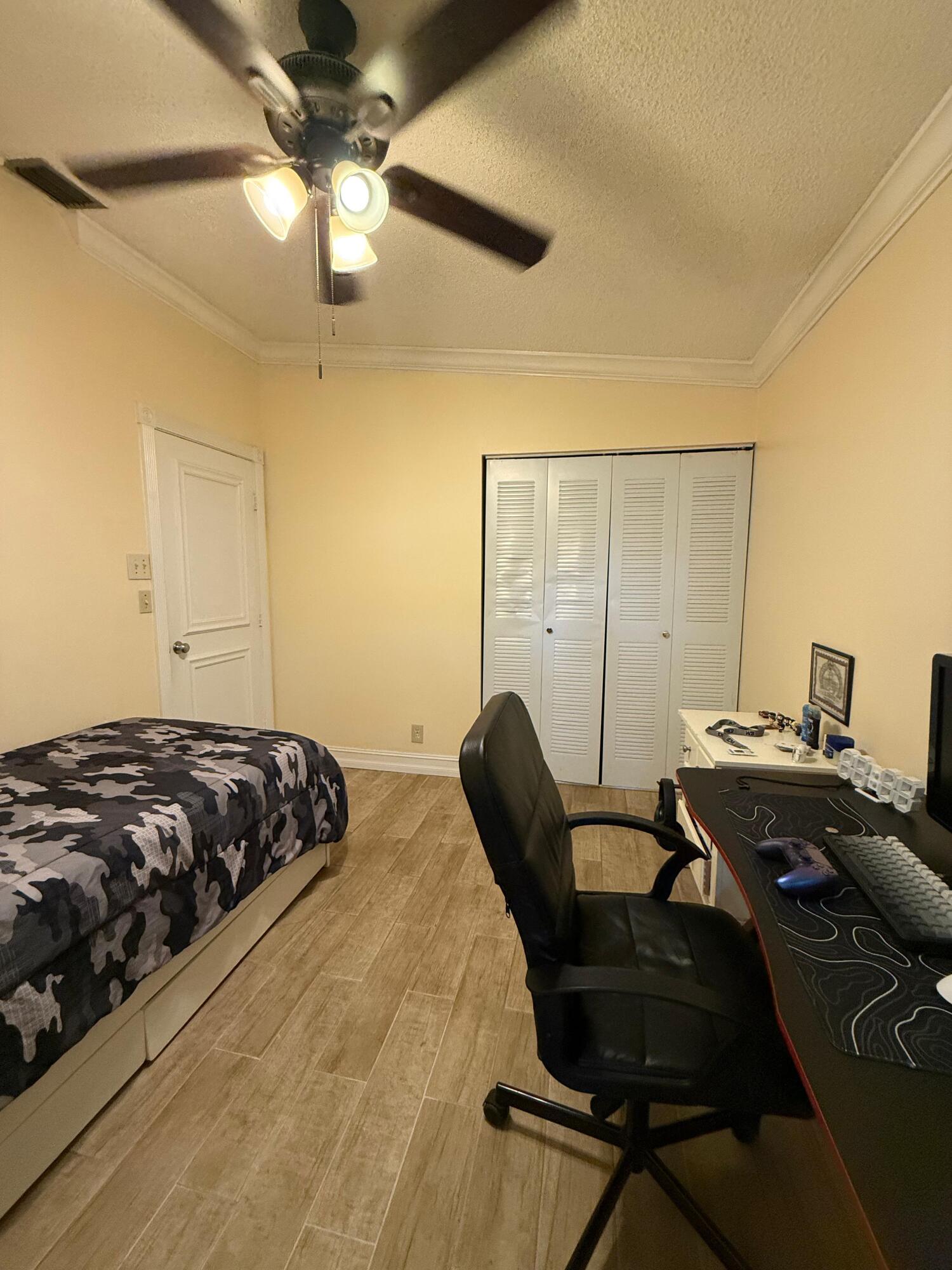 22293 Misty Woods Way Boca Raton, FL 33428 - Photo 13 of 23 a bedroom with a bed and a desk