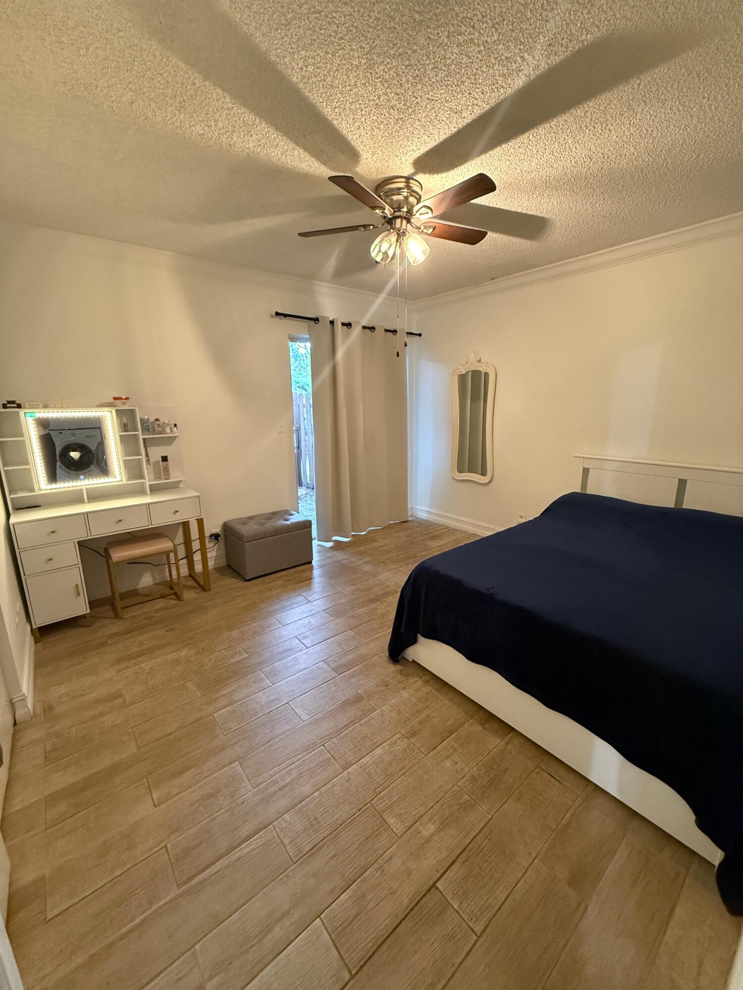 22293 Misty Woods Way Boca Raton, FL 33428 - Photo 17 of 23 a spacious bedroom with a bed and a chandelier