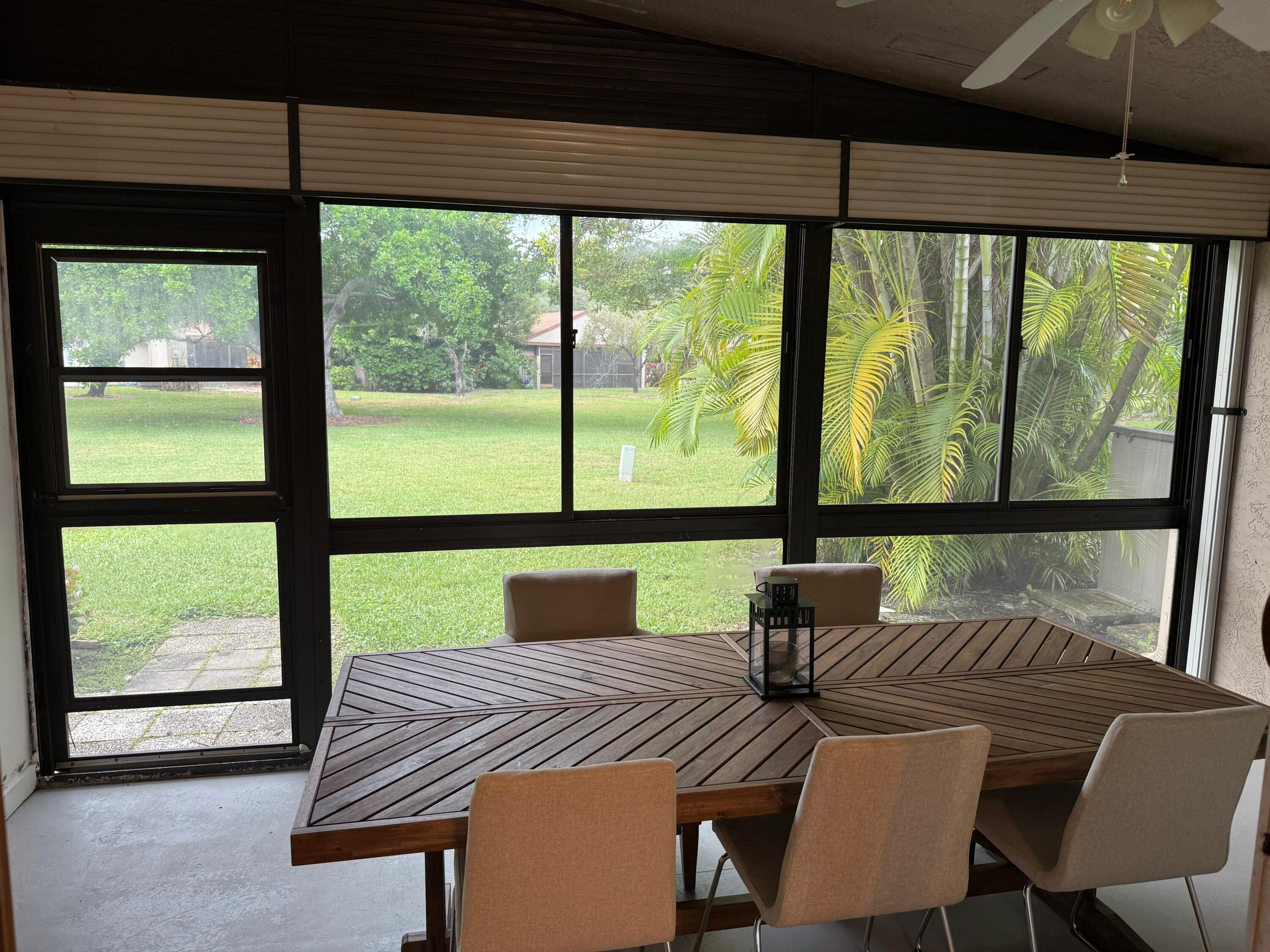 22293 Misty Woods Way Boca Raton, FL 33428 - Photo 21 of 23 a view of a city from a dining room with large windows