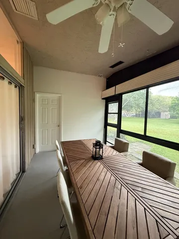 a bedroom with a bed and large windows