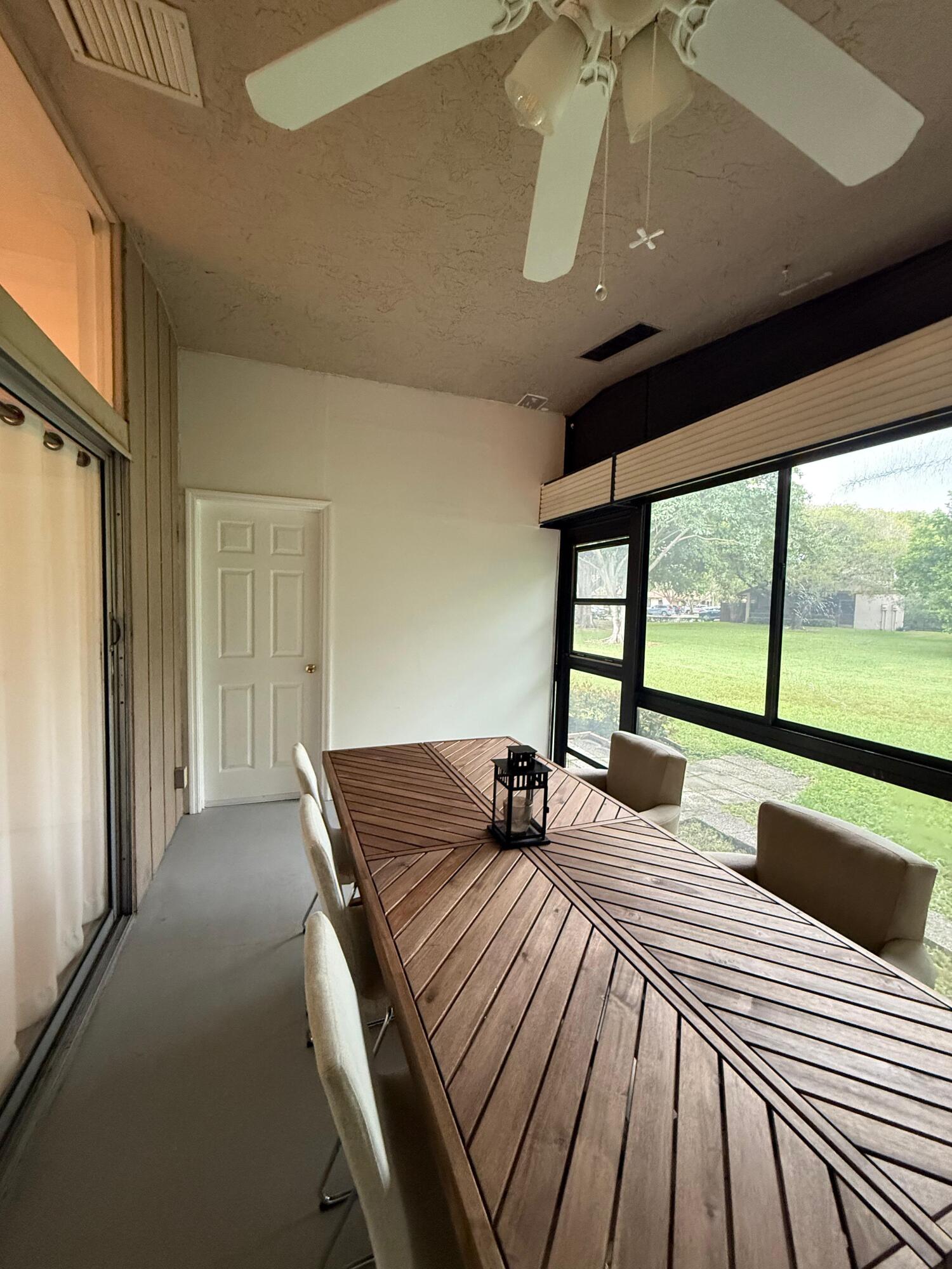 22293 Misty Woods Way Boca Raton, FL 33428 - Photo 23 of 23 a bedroom with a bed and large windows