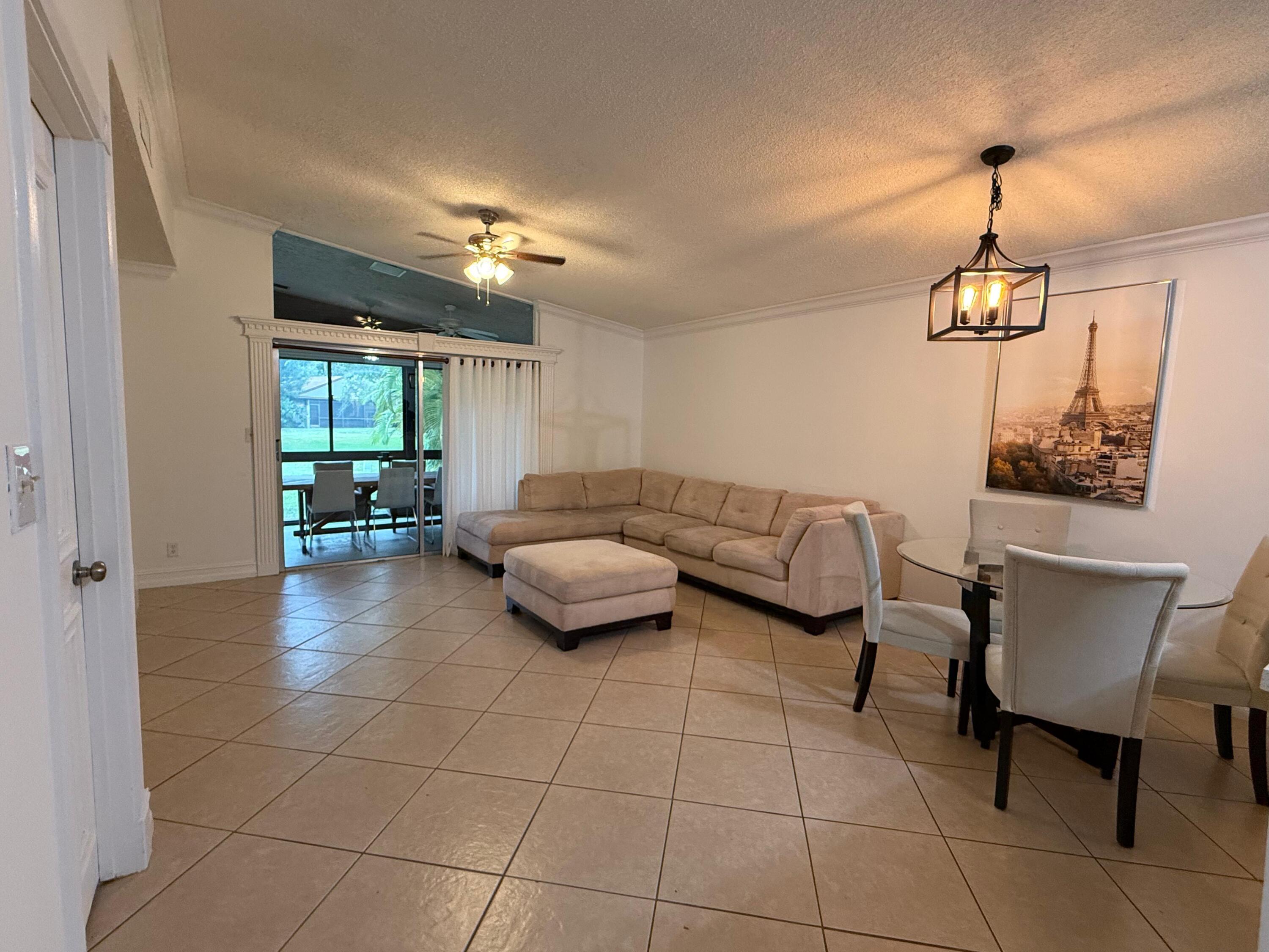 22293 Misty Woods Way Boca Raton, FL 33428 - Photo 4 of 23 a living room with furniture and a chandelier