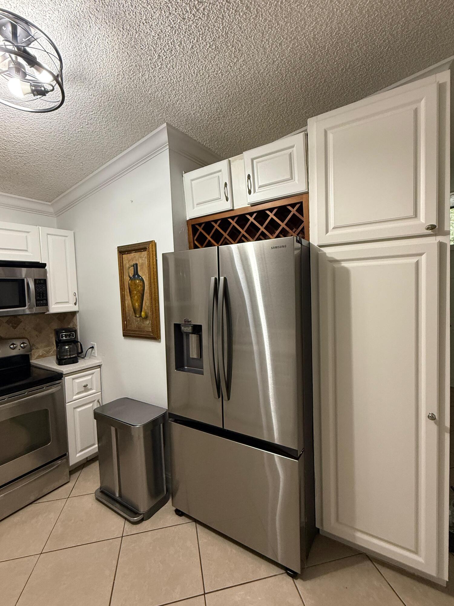 22293 Misty Woods Way Boca Raton, FL 33428 - Photo 9 of 23 a metallic refrigerator freezer sitting in a kitchen