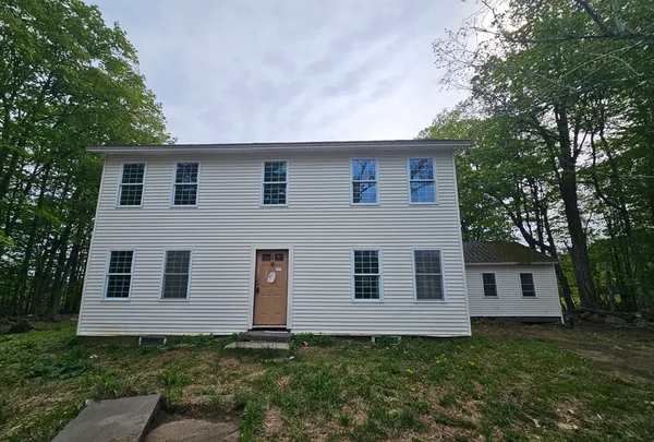 a house that has a tree in front of the house