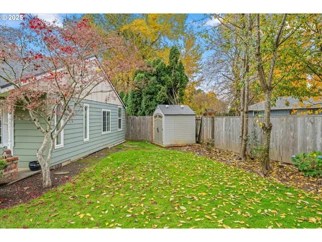 an aerial view of a house with a garden and trees