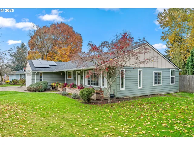 an aerial view of a house with garden space and street view