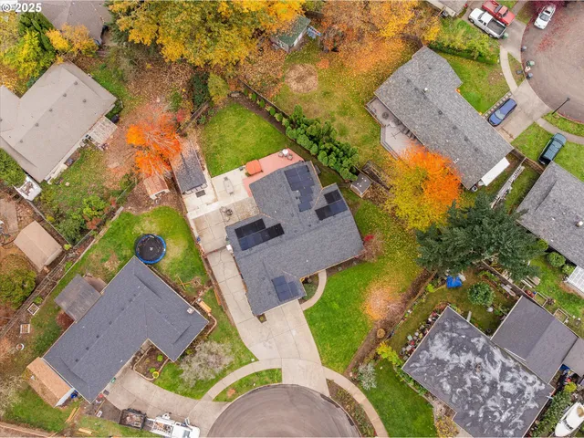 an aerial view of a house with a yard basket ball court and outdoor seating