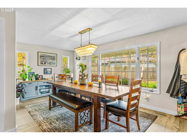 a dining room with furniture and a floor to ceiling window