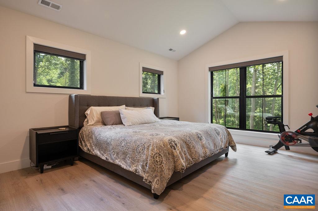 92 Key W Drive Charlottesville, VA 22911 - Photo 16 of 27 a bedroom with a bed a table and a large window