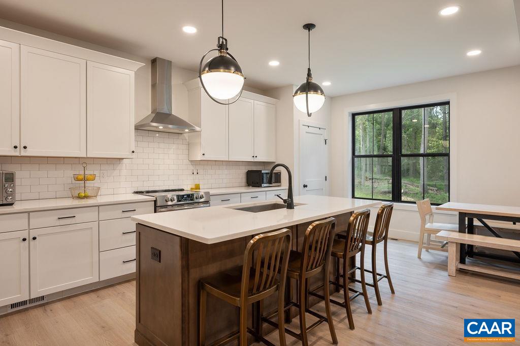 92 Key W Drive Charlottesville, VA 22911 - Photo 8 of 27 a kitchen with a table chairs sink and cabinets