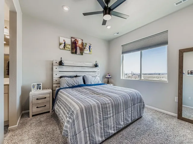 a bedroom with a bed and a painting on the wall