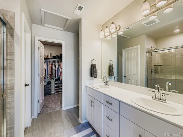 a spacious bathroom with a double vanity sink mirror and double