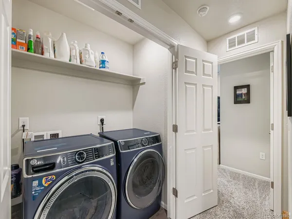 a utility room with closet dryer and washer