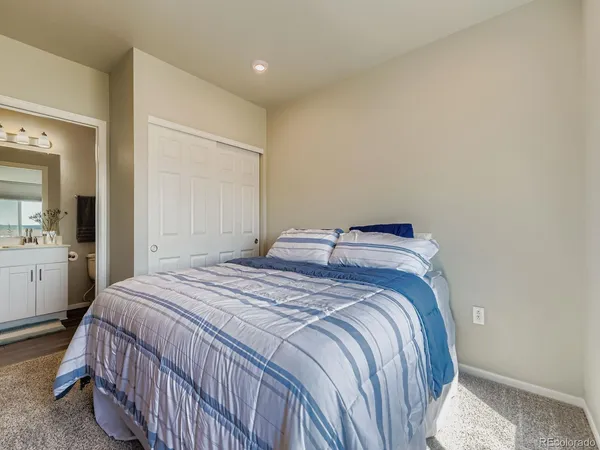 a bedroom with a bed and a view of bathroom