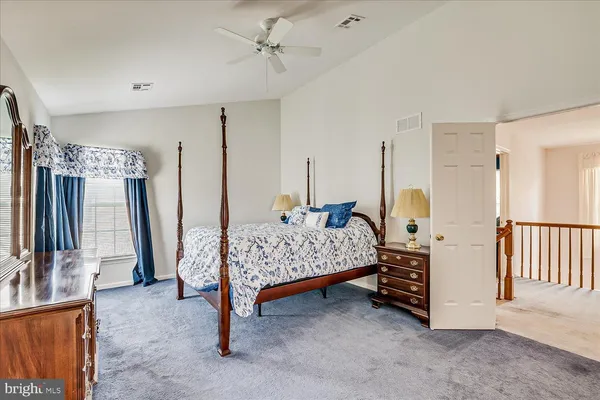 a bedroom with a bed next to a window