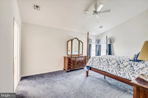 a bedroom with a bed dresser and a window