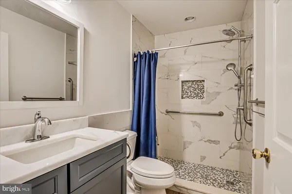 a bathroom with a sink toilet and shower