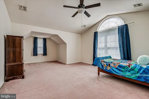 a bedroom with bed and window