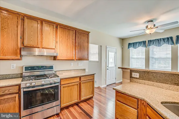 a kitchen with a stove a sink and a refrigerator