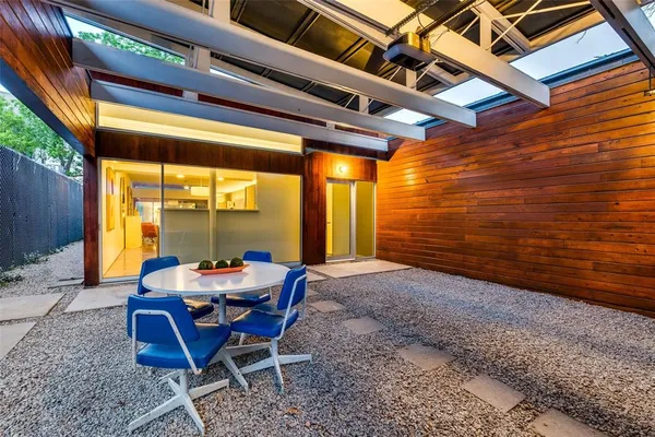 a view of a patio with table and chairs and wooden floor