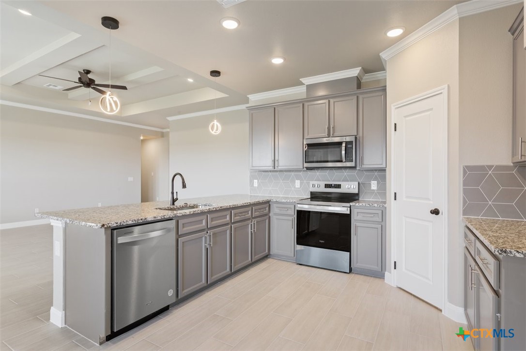 3824 Keller Road Temple, TX 76504 - Photo 11 of 28 a kitchen with stainless steel appliances granite countertop a stove sink and cabinets