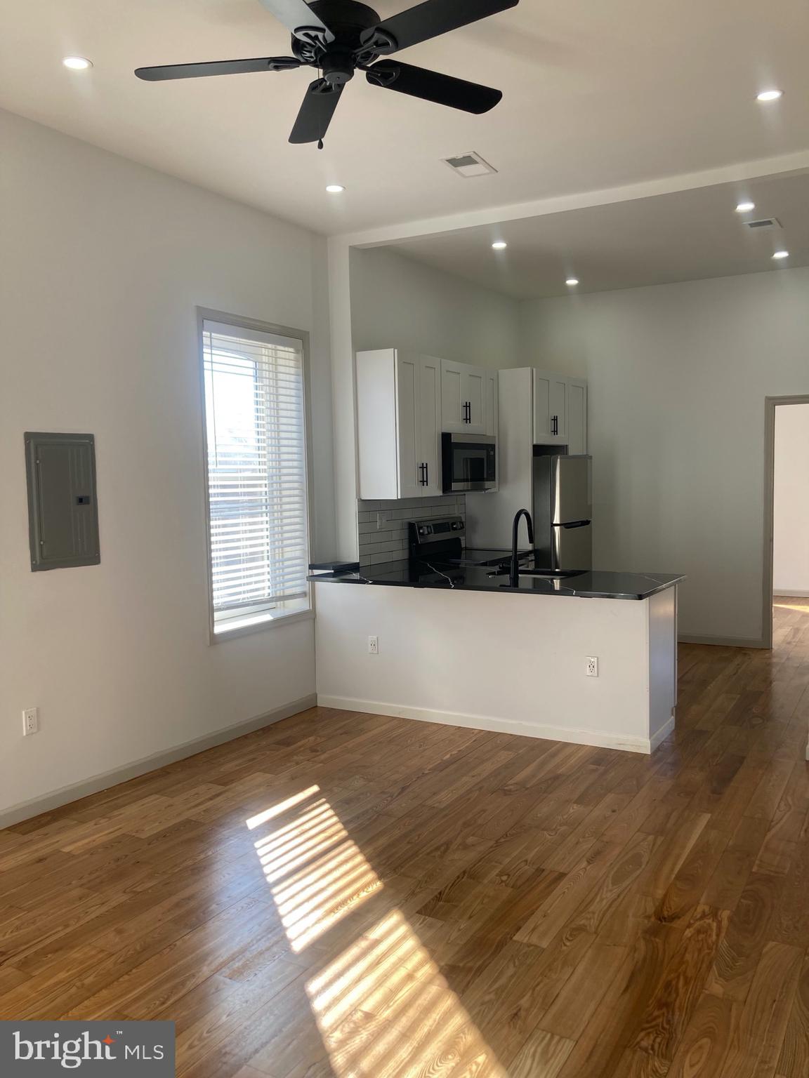 a view of kitchen with cabinets and wooden floor