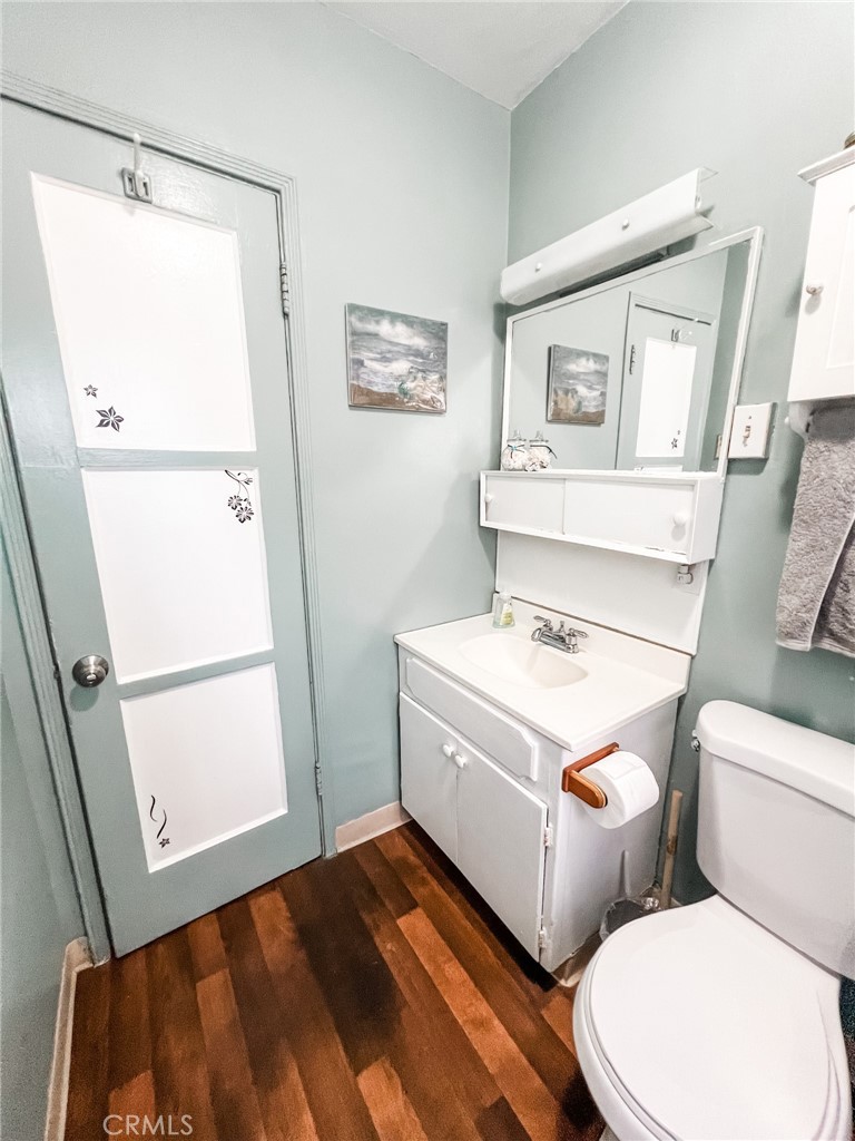 8206 Jackson Street Paramount, CA 90723 - Photo 2 of 9 a bathroom with a sink a toilet and a window
