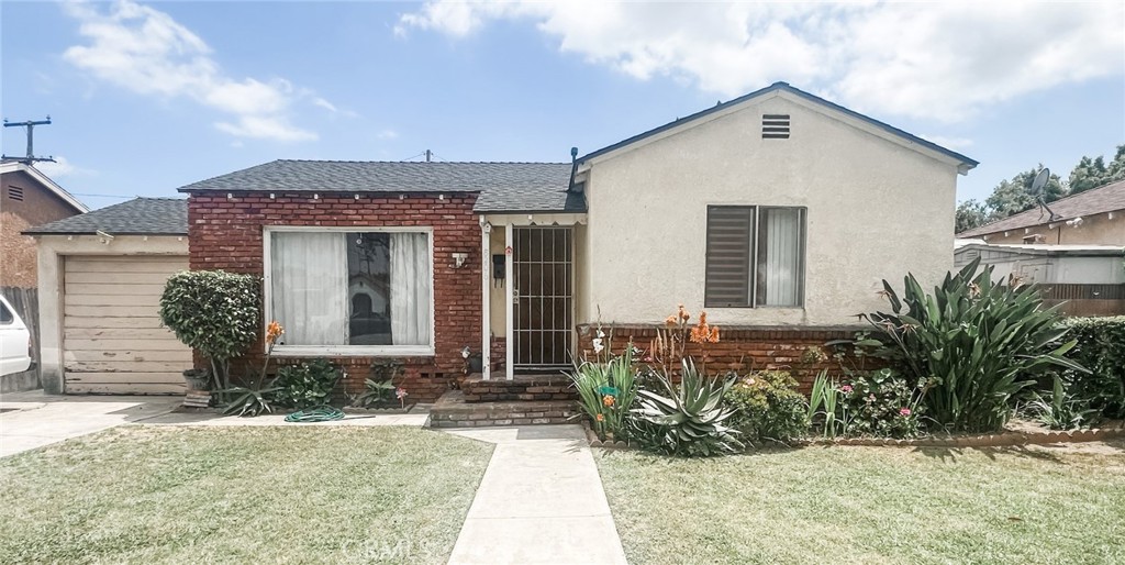 8206 Jackson Street Paramount, CA 90723 - Photo 8 of 9 a front view of a house with garden